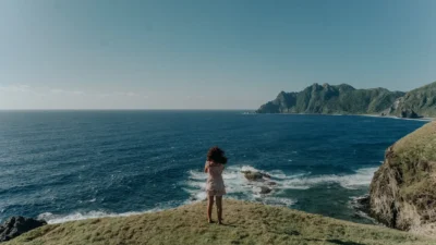 Blogger Standing at a Cliff Near Beach